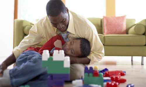 Father and Son Playing Together at Home --- Image by © Royalty-Free/Corbis