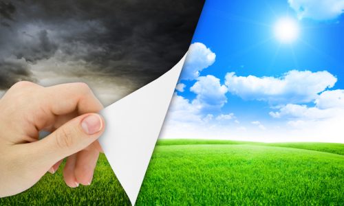 Blank sheet of paper with hand opening it. Storm changes to good weather. Nature background