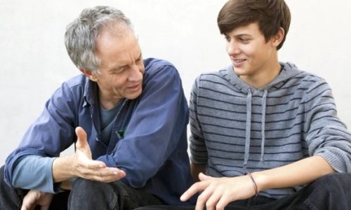 Father and son sitting together