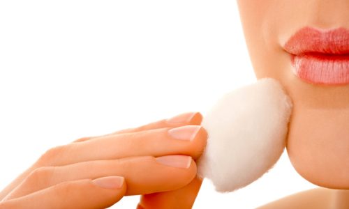 Female using cotton ball to face make-up
