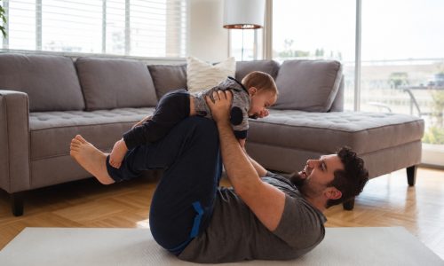 father-playing-with-his-baby-living-room 2