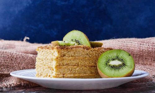 A slice of medovic cake with kiwies. High quality photo