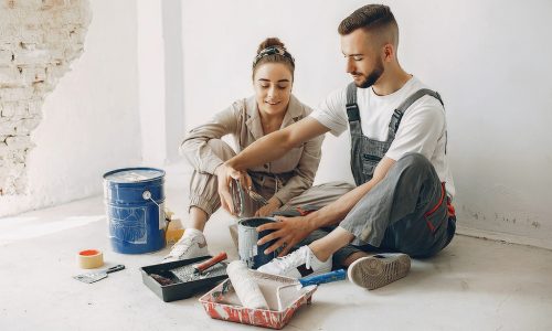Family repairs. Couple at home. Woman in a overalls